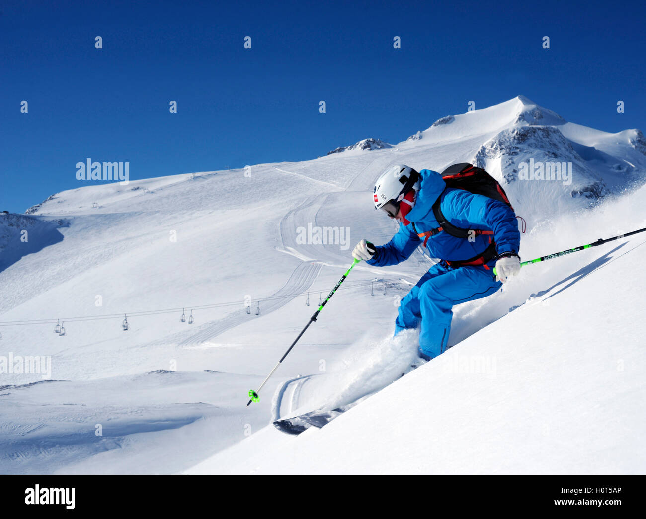 skier in snowy mountain scenery, Grande Motte in background, France, Savoie, Tignes Stock Photo