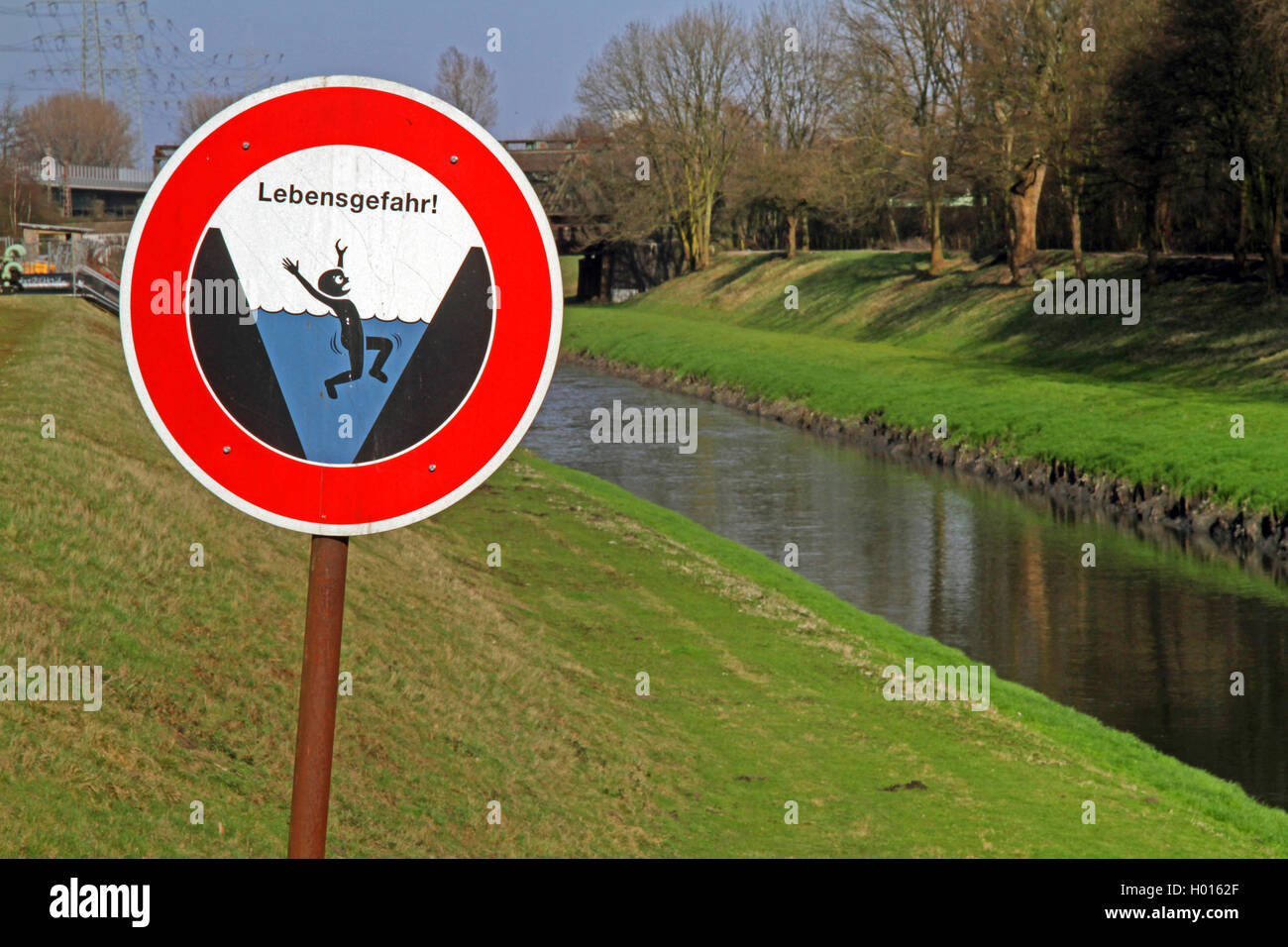 warning sign of drawning and open waste water canal Emscher , Germany Stock Photo