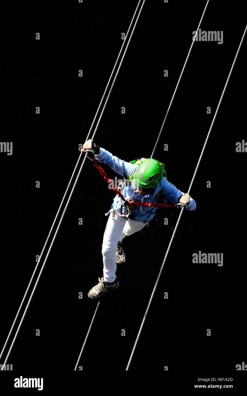 climber crossing a simple suspension bridge, Via ferrata de Tende voie du chateau des Comtes Lascaris, France, Alpes Maritimes, Tende Stock Photo