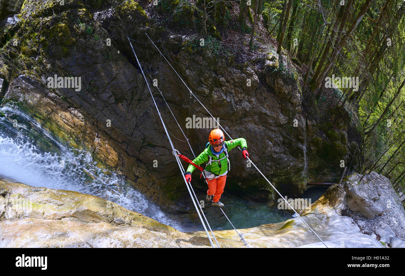 climber at waterfall of the Nants, Via Ferrata de Bellevaux, France, Haute-Savoie Stock Photo