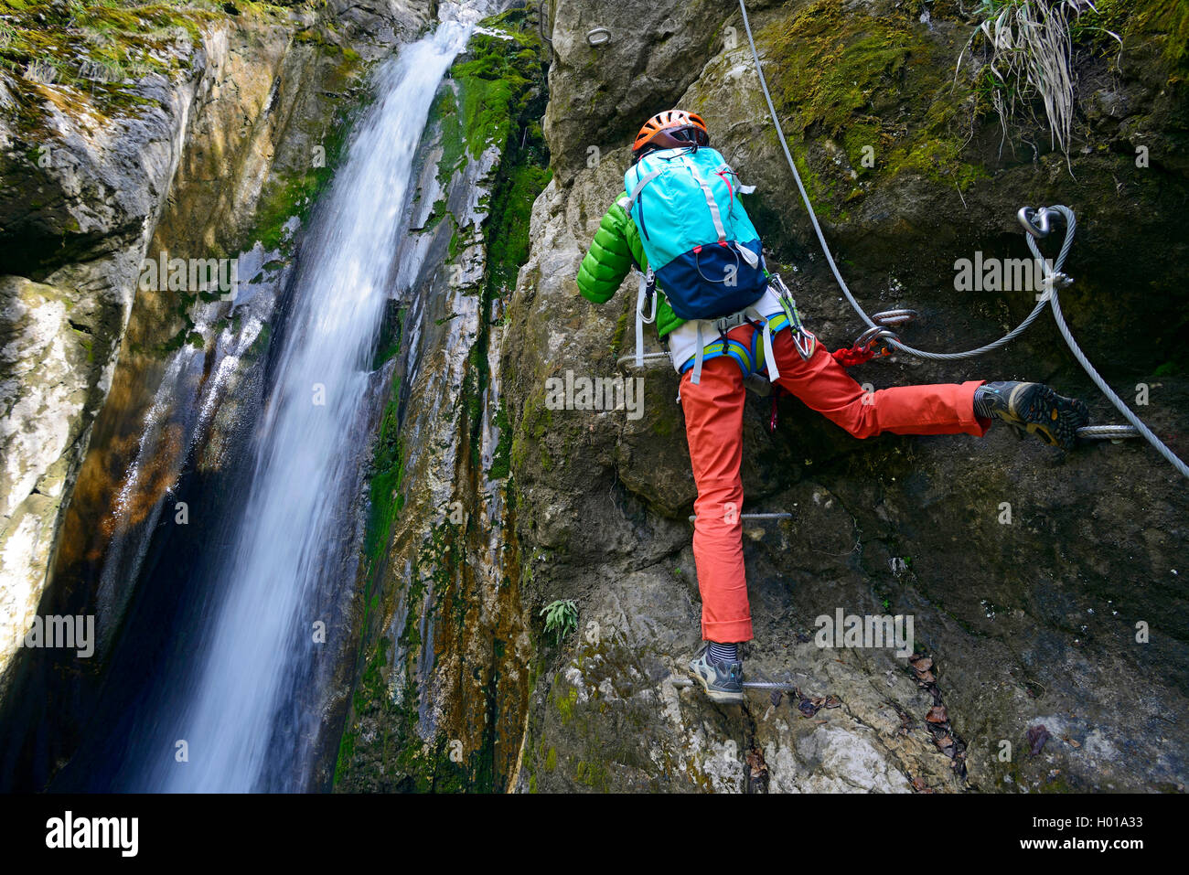 climber at waterfall of the Nants, Via Ferrata de Bellevaux, France, Haute-Savoie Stock Photo