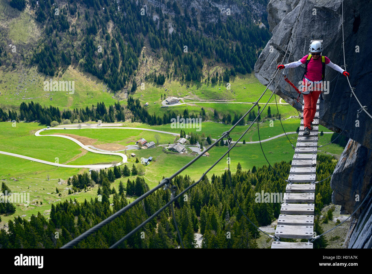 climber on simple suspension bridge, Via ferrata Yves Pollet-Villard, France, Haute Savoie, La Clusaz Stock Photo