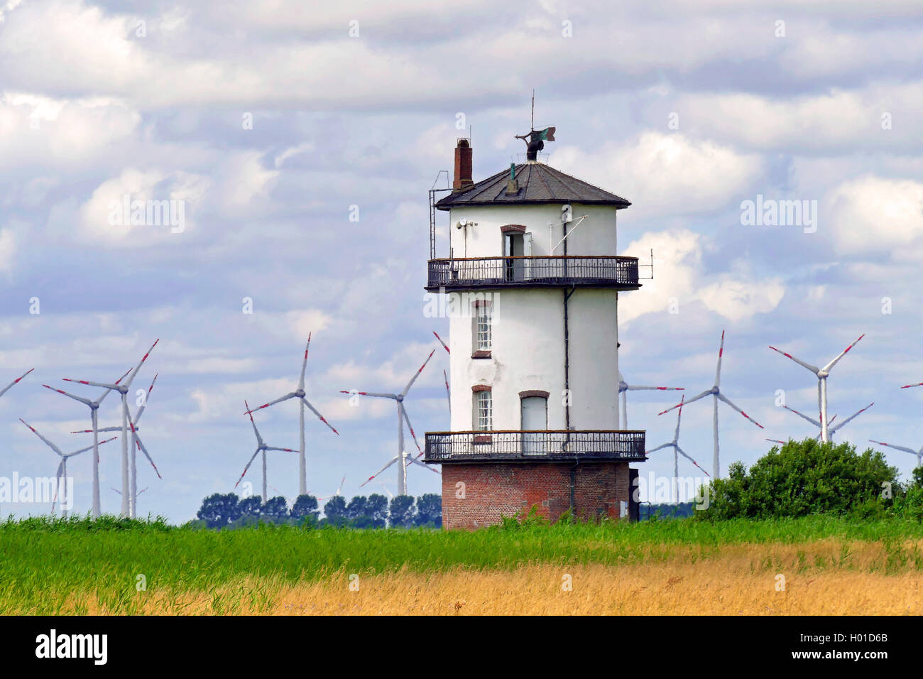 old Baljer lighthouse at the bird reserve Nordkehdingen, in the background a windpark in Schleswig Holstein, Germany, Lower Saxony Stock Photo