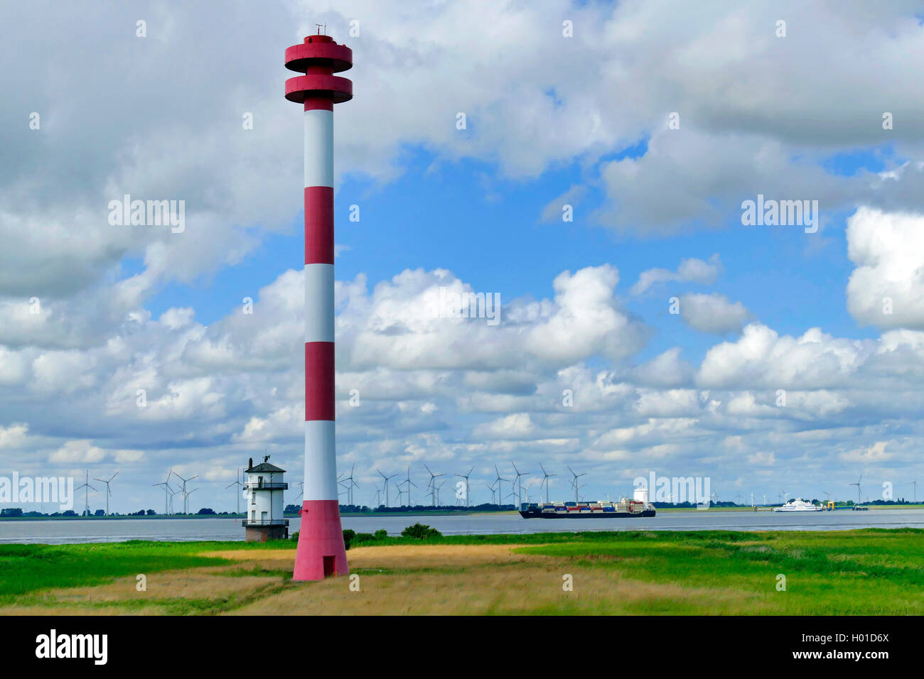 old Baljer lighthouse at the bird reserve Nordkehdingen, in the background a windpark in Schleswig Holstein, Germany, Lower Saxony Stock Photo