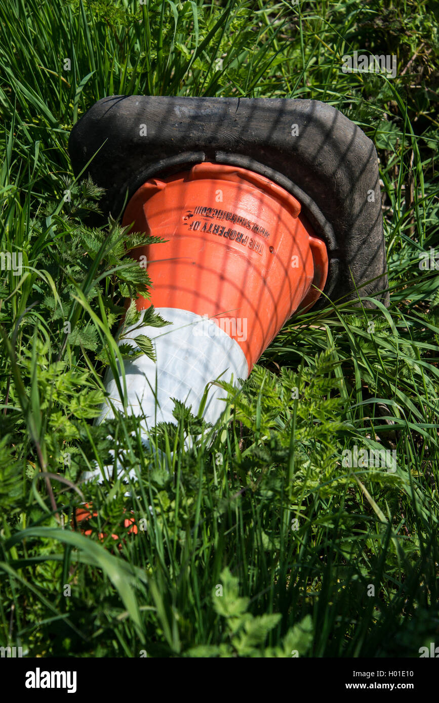 Abandoned traffic cone on a grass verge Stock Photo