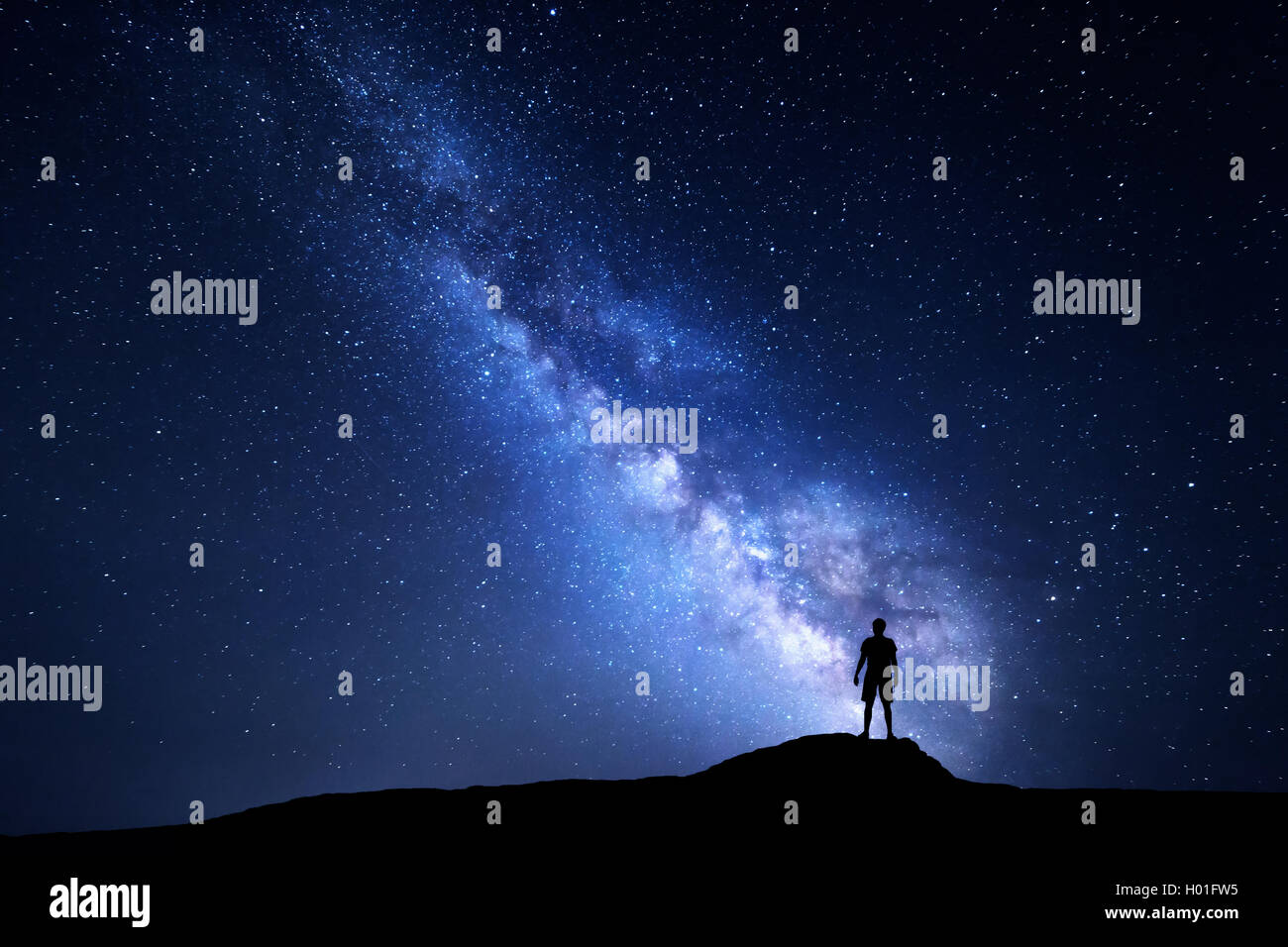 Milky Way. Beautiful night sky with stars and silhouette of a standing ...
