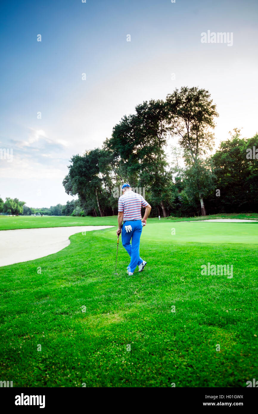 beautiful scenery with a golfer, course, sunset landscape Stock Photo