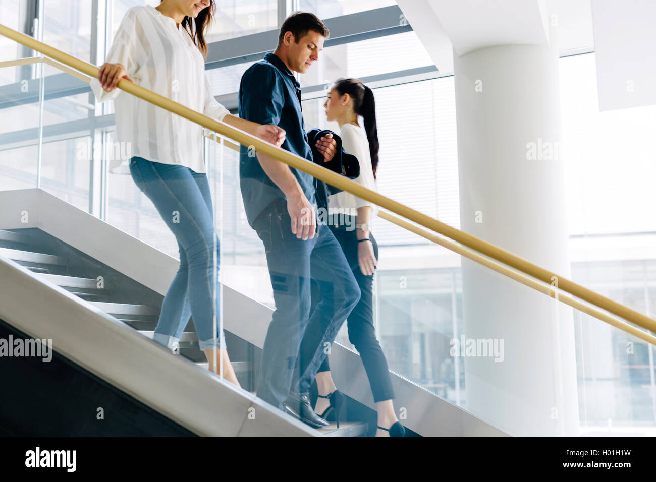 Group of businessman walking and taking stairs in an office building ...