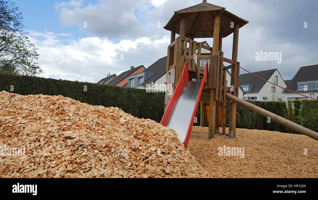 children's playground with wood chip as fall protection in a residential area Stock Photo