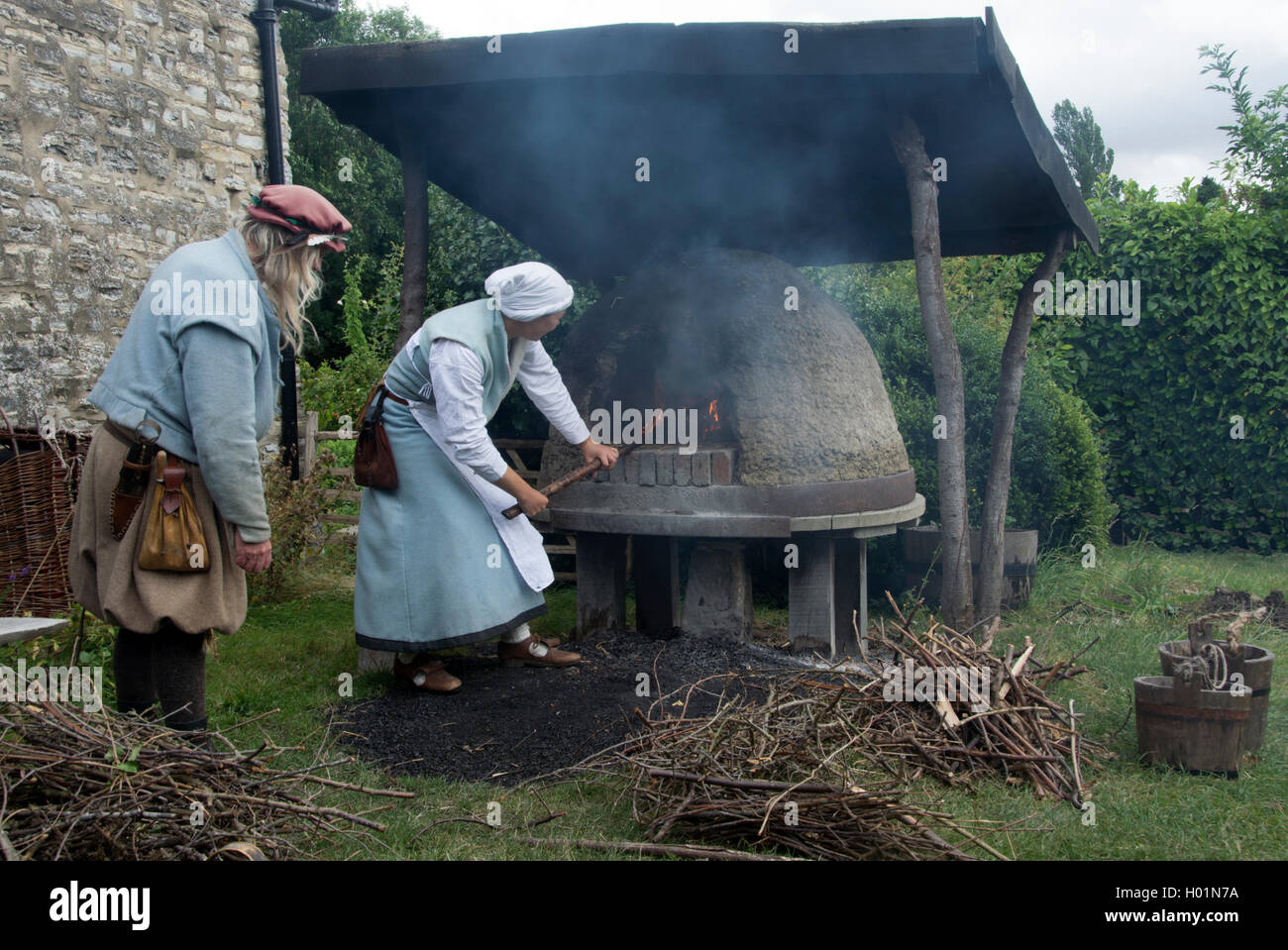 WARWICKSHIRE: WILMCOTE: SHAKESPEARE BIRTHPLACE TRUST; MARY ARDEN'S TUDOR FARM;  LIGHTING THE TUDOR  BREAD OVEN Stock Photo