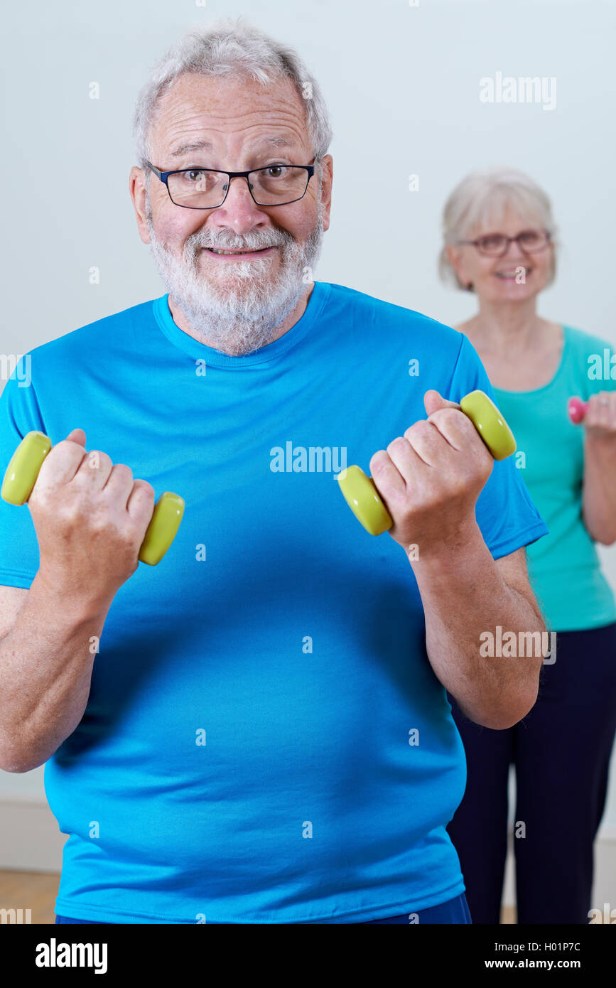 Senior Couple In Fitness Class Using Weights Stock Photo