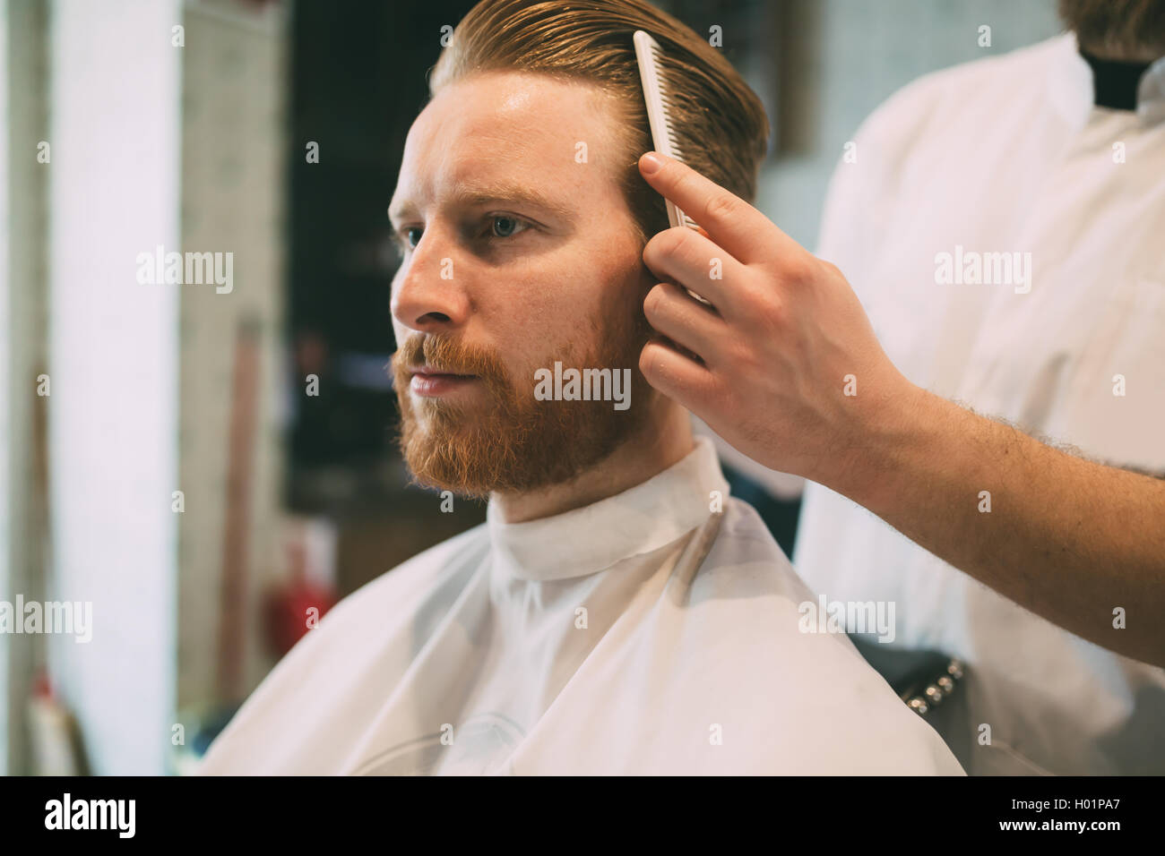 Combing of hair and styling in barber shop Stock Photo
