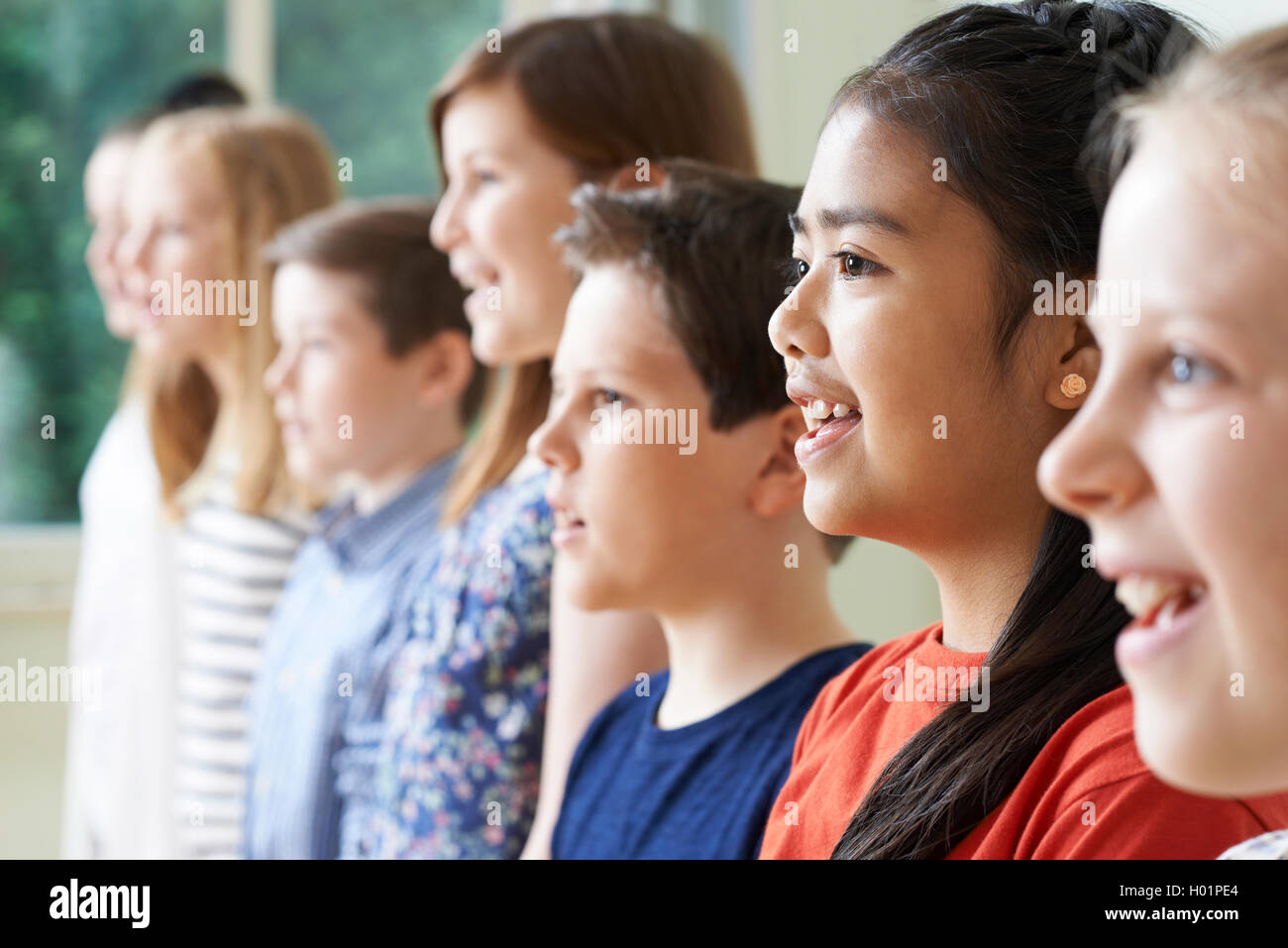 Group Of Children Enjoying Singing Group Stock Photo