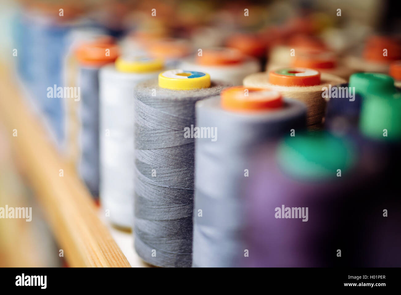 Colorful thread spools used in fabric and textile industry Stock Photo