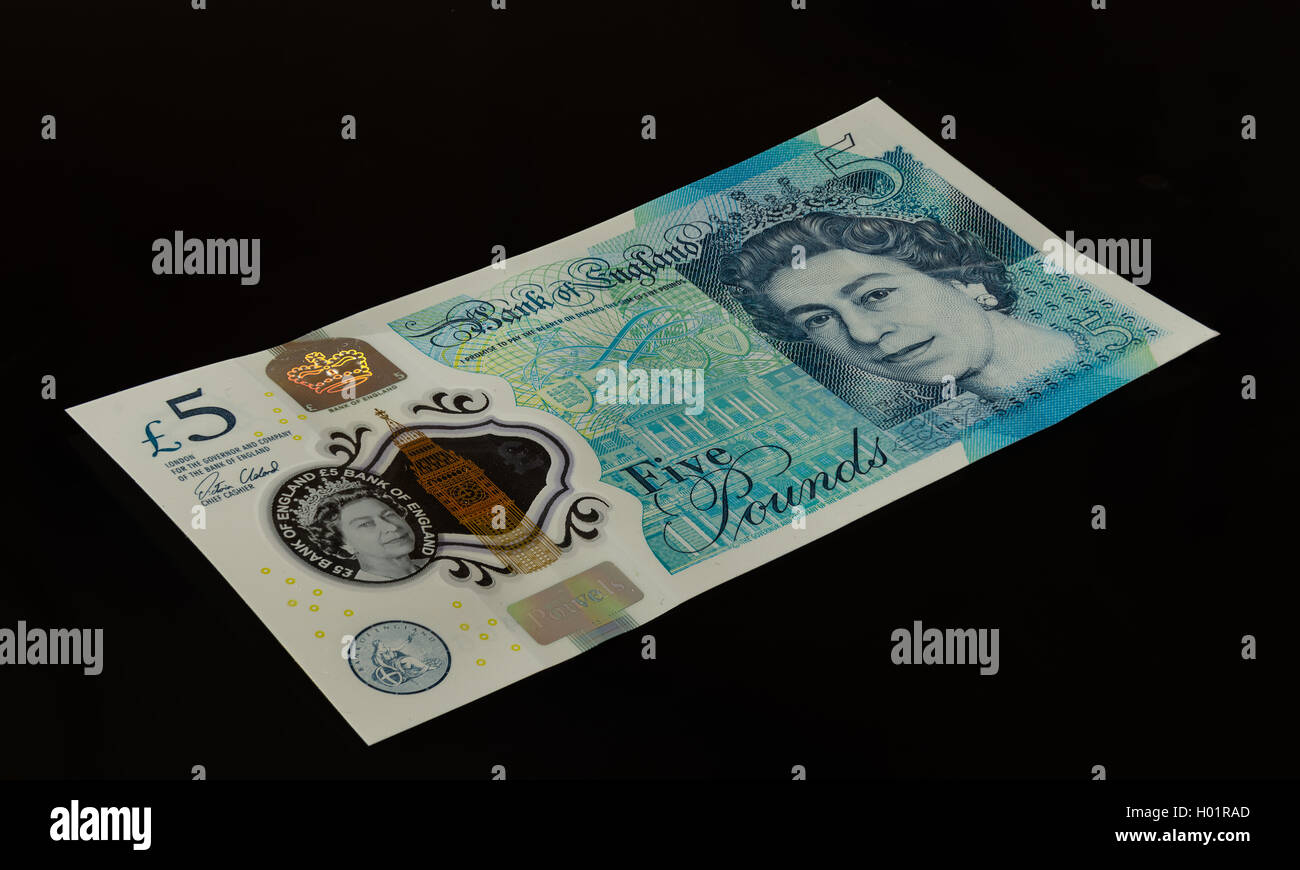 The front of new 'Fiver' five pound note from the Bank of England. Isolated on a plain black background. Stock Photo