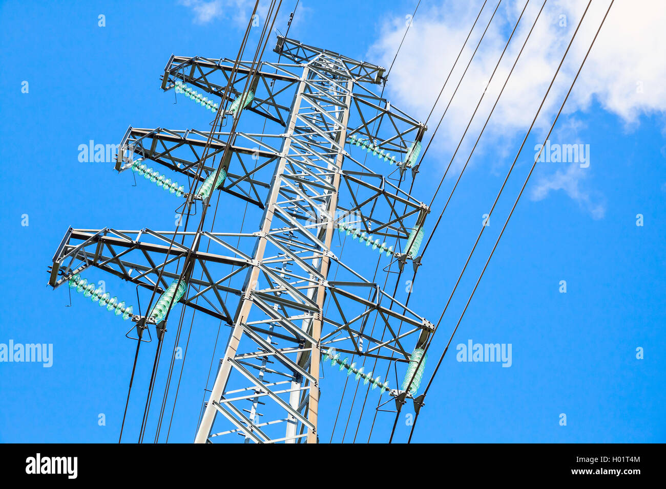 Lattice-type steel tower as a part of high-voltage line. Overhead power line details Stock Photo