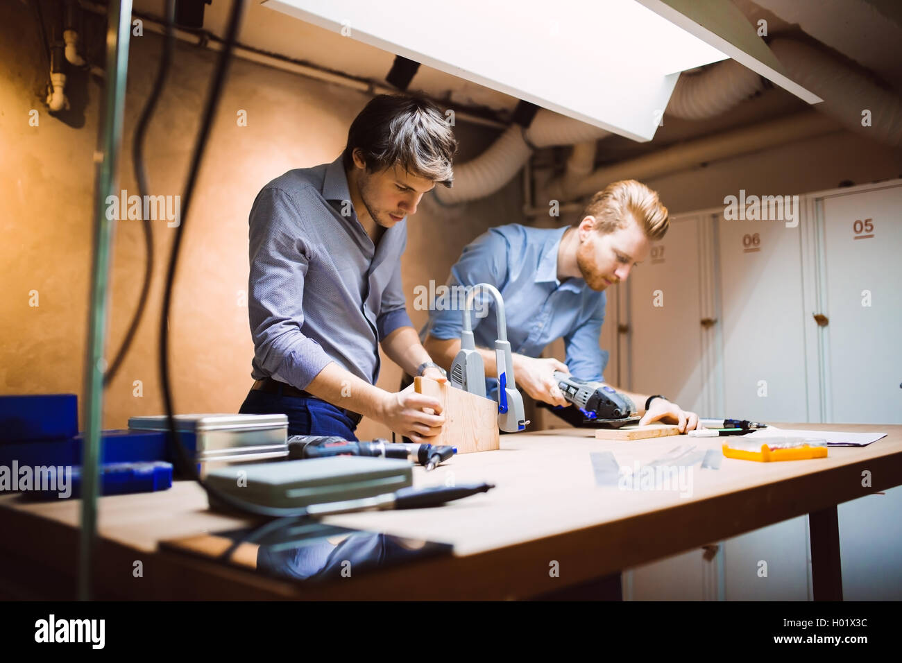 Two designers working together in workshop with precision tools Stock Photo