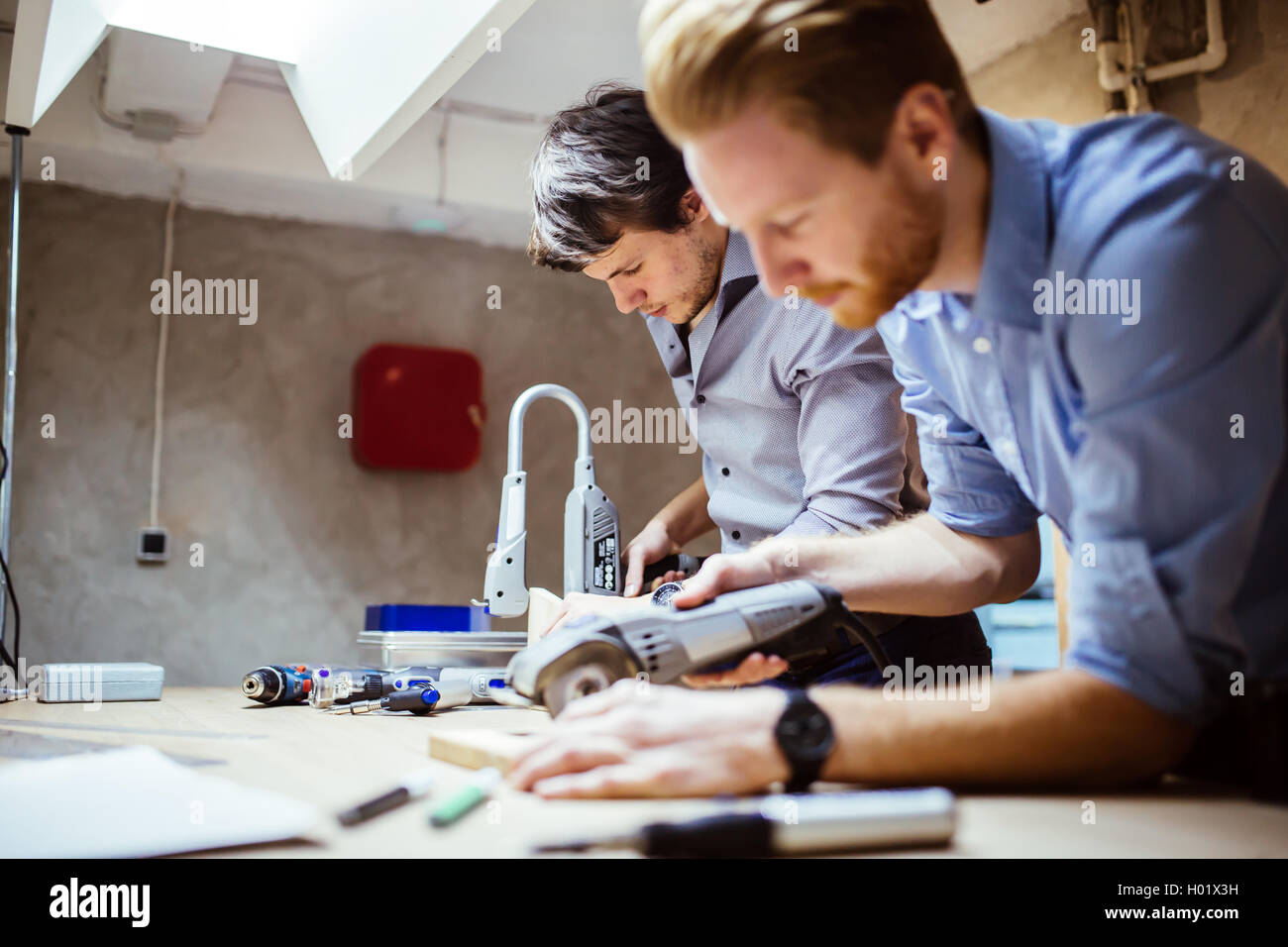 Two designers working on a project in workshop with joint effort Stock Photo