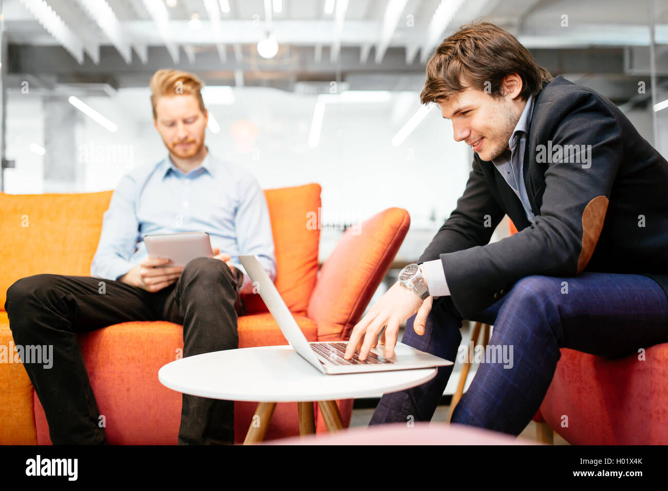 Business colleagues resting and talking during break Stock Photo