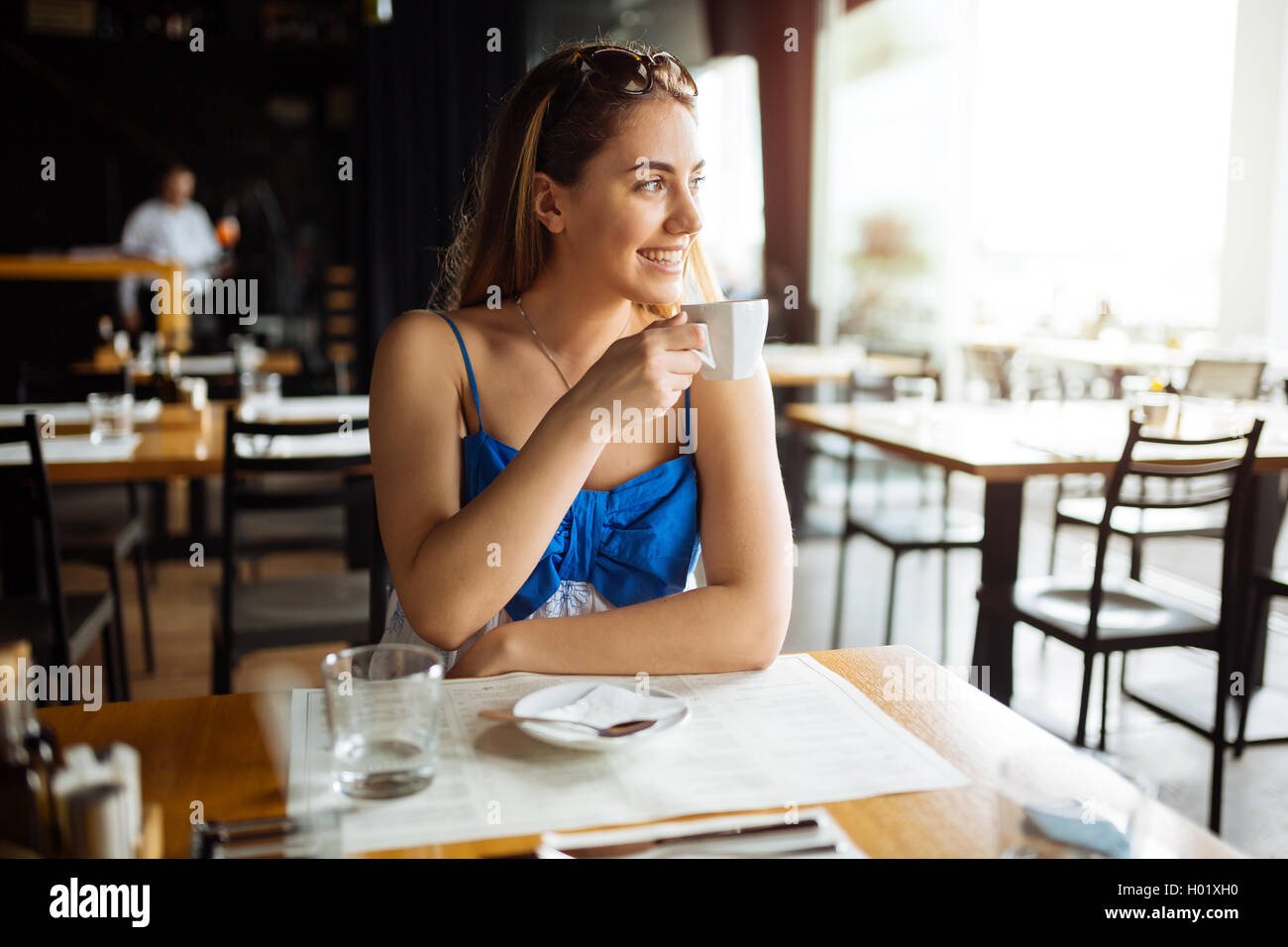 Beautiful woman drinking coffee in restaurant Stock Photo