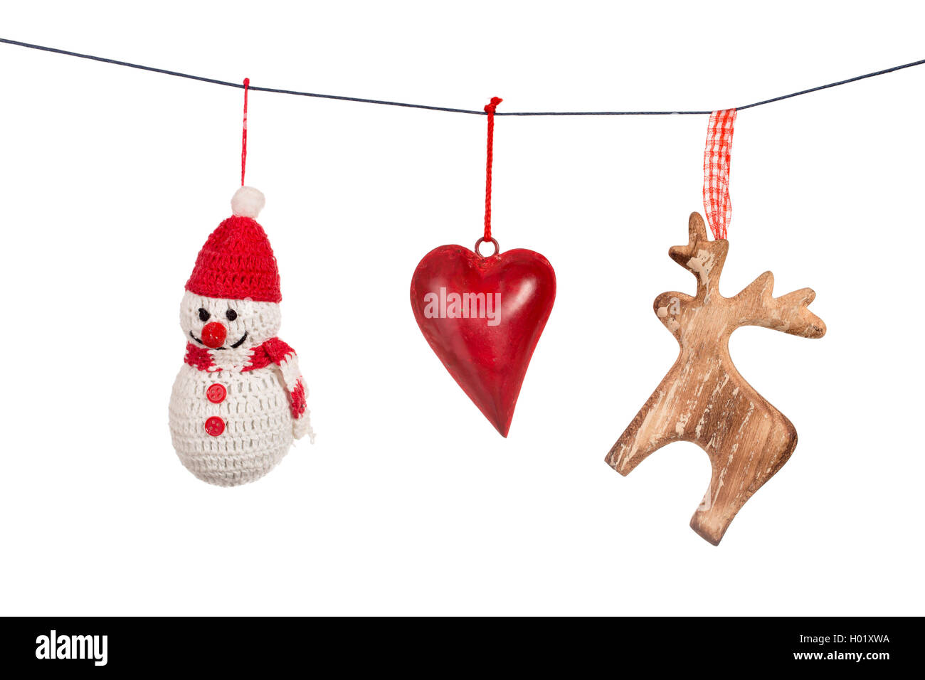 Various Christmas decorations hanging on string isolated Stock Photo