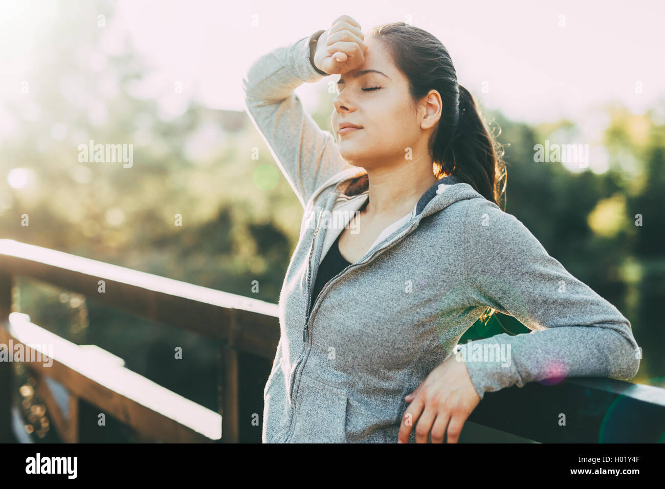 Beautiful female tired after jogging taking a break Stock Photo Alamy