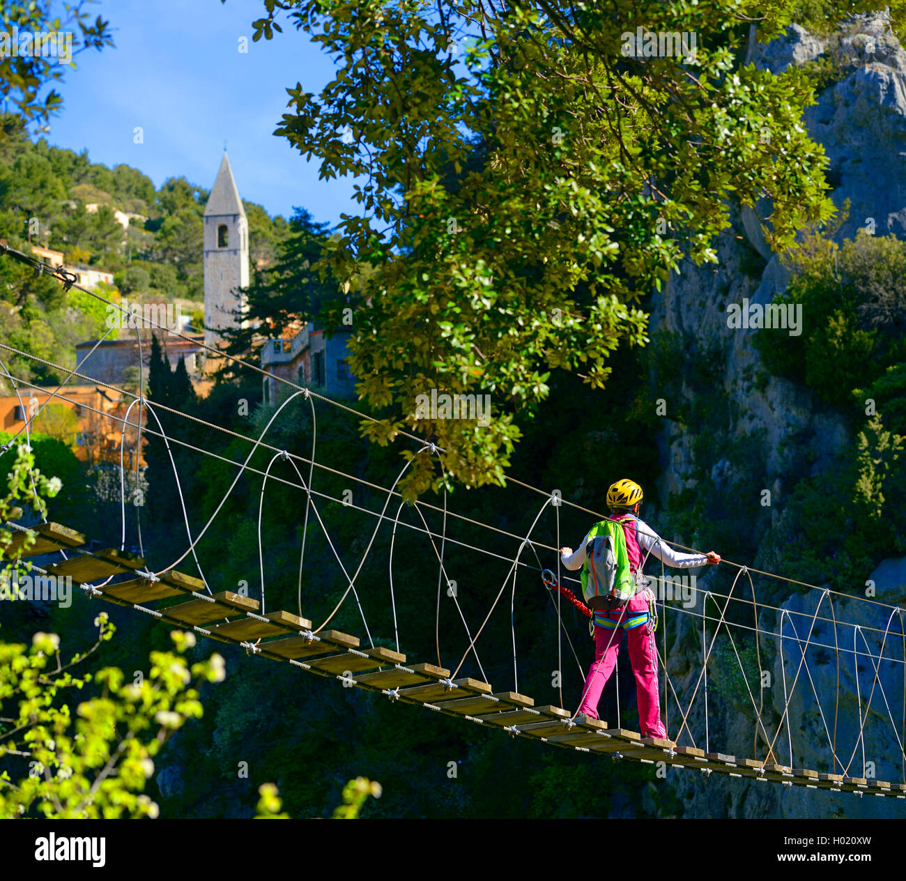 climber on suspension bridge crossing a gorge, Via ferrata Escale a Peille, France, Cotes D. Azur, Peille Stock Photo
