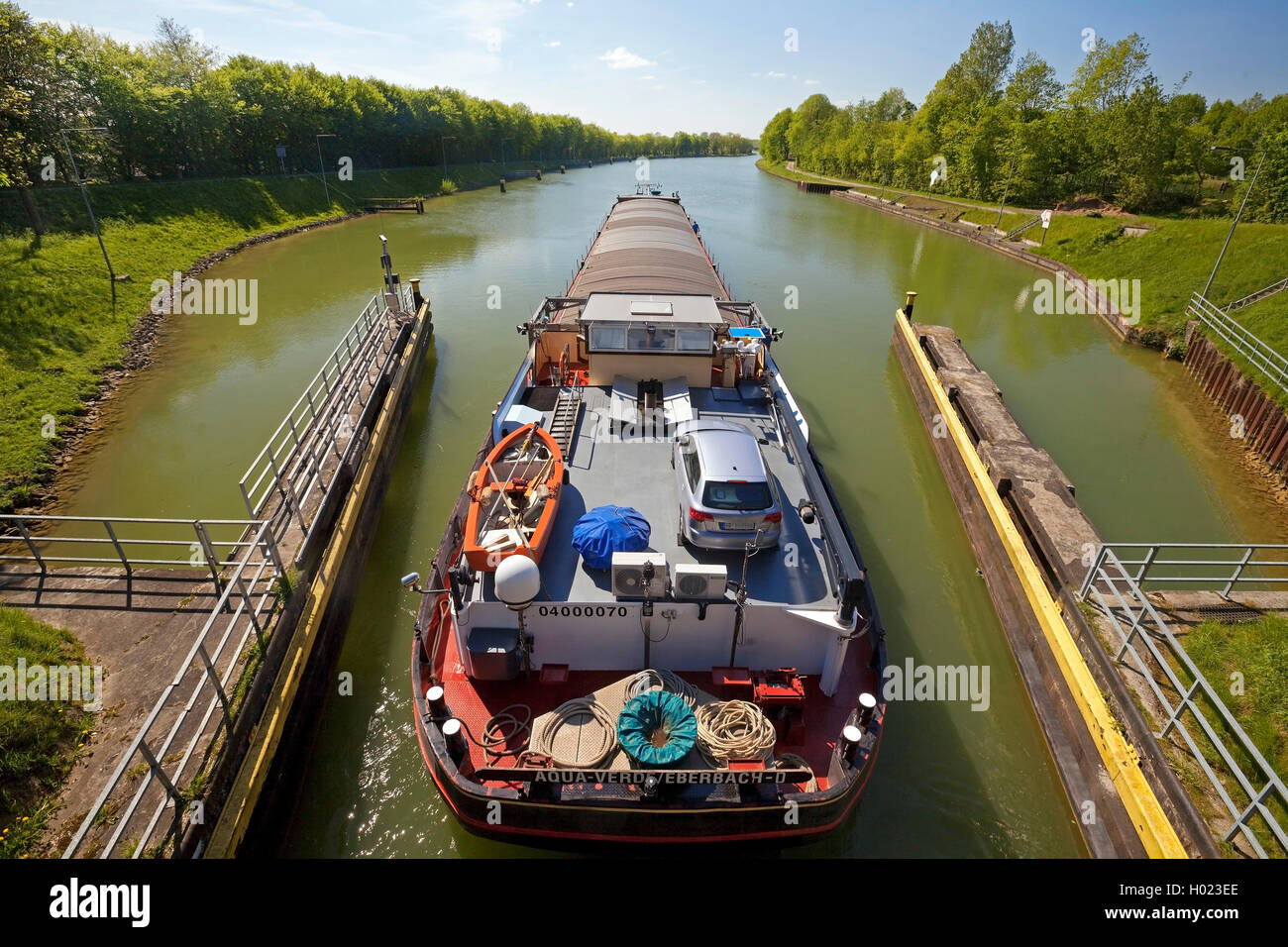 barge leaving the lock Bevergern, Dortmund Ems Canal, Germany, North Rhine-Westphalia, Muensterland, Hoerstel Stock Photo