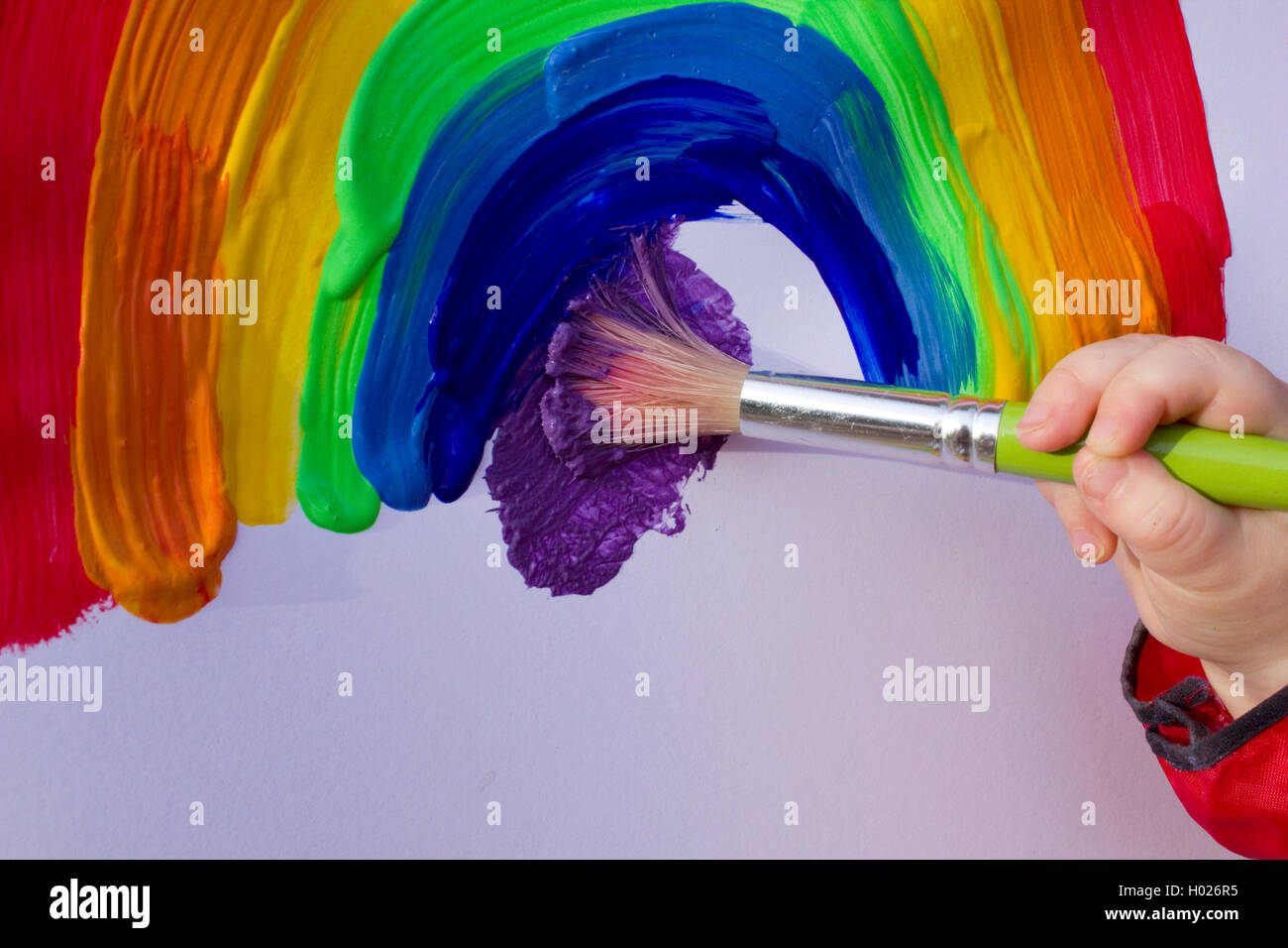 School girl painting a rainbow Stock Photo