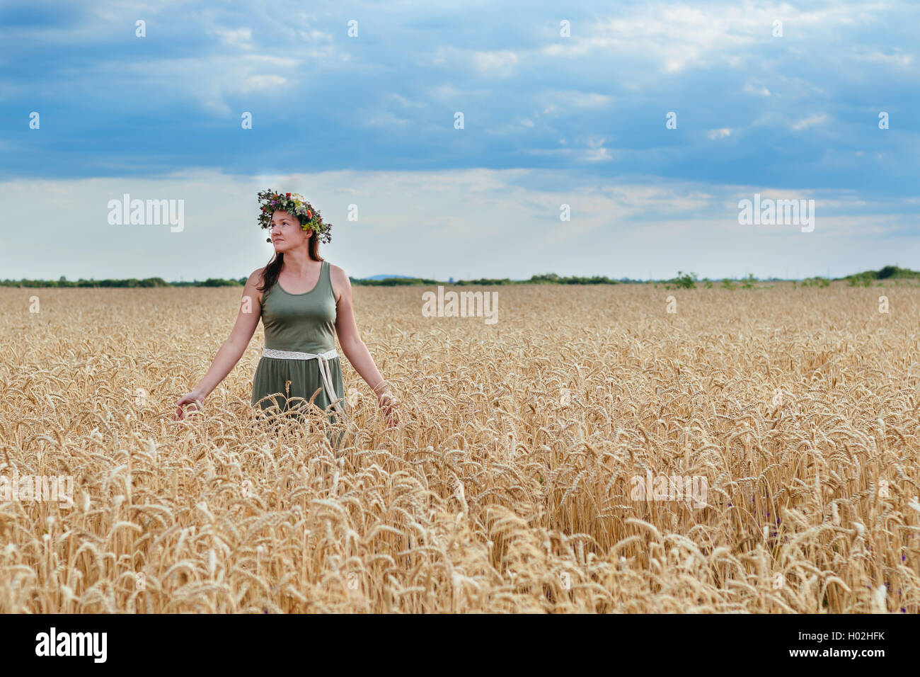 beautiful girl in a wheat field with wreath on head Stock Photo - Alamy