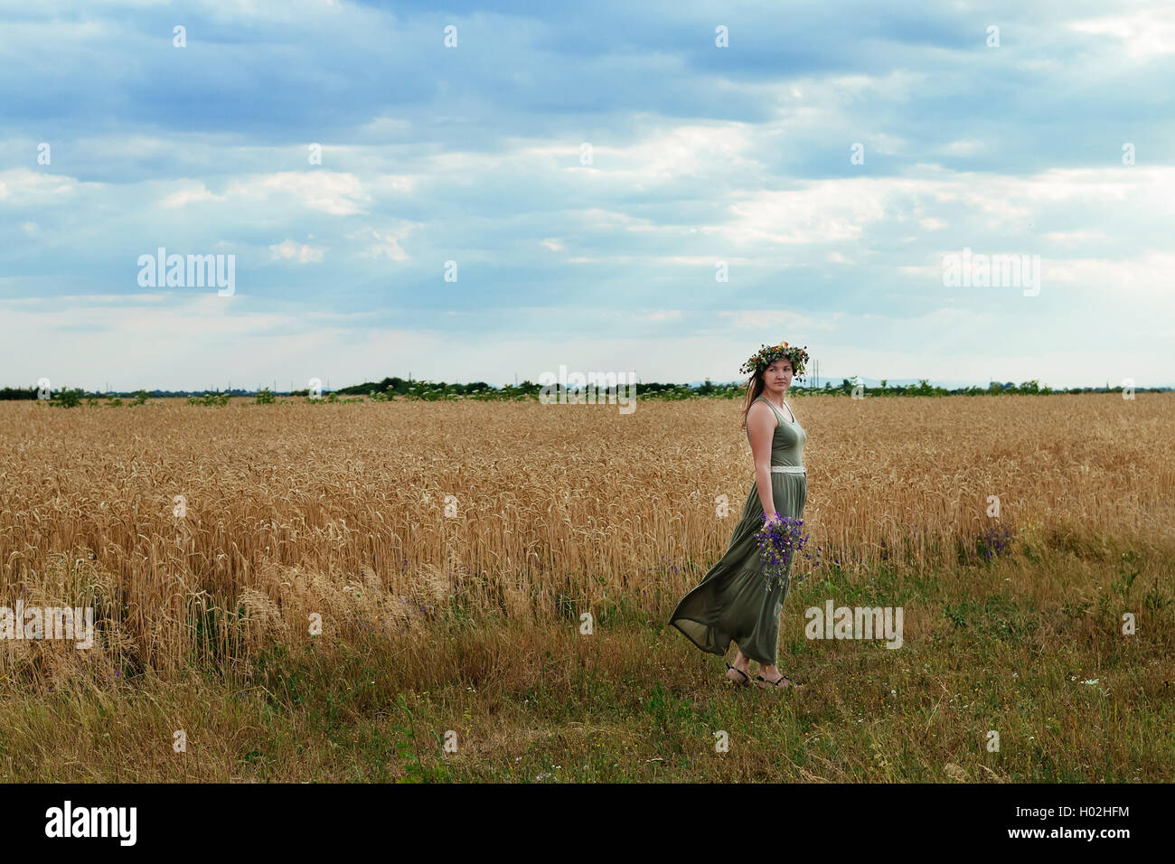 beautiful girl in a wheat field with wreath on head Stock Photo - Alamy