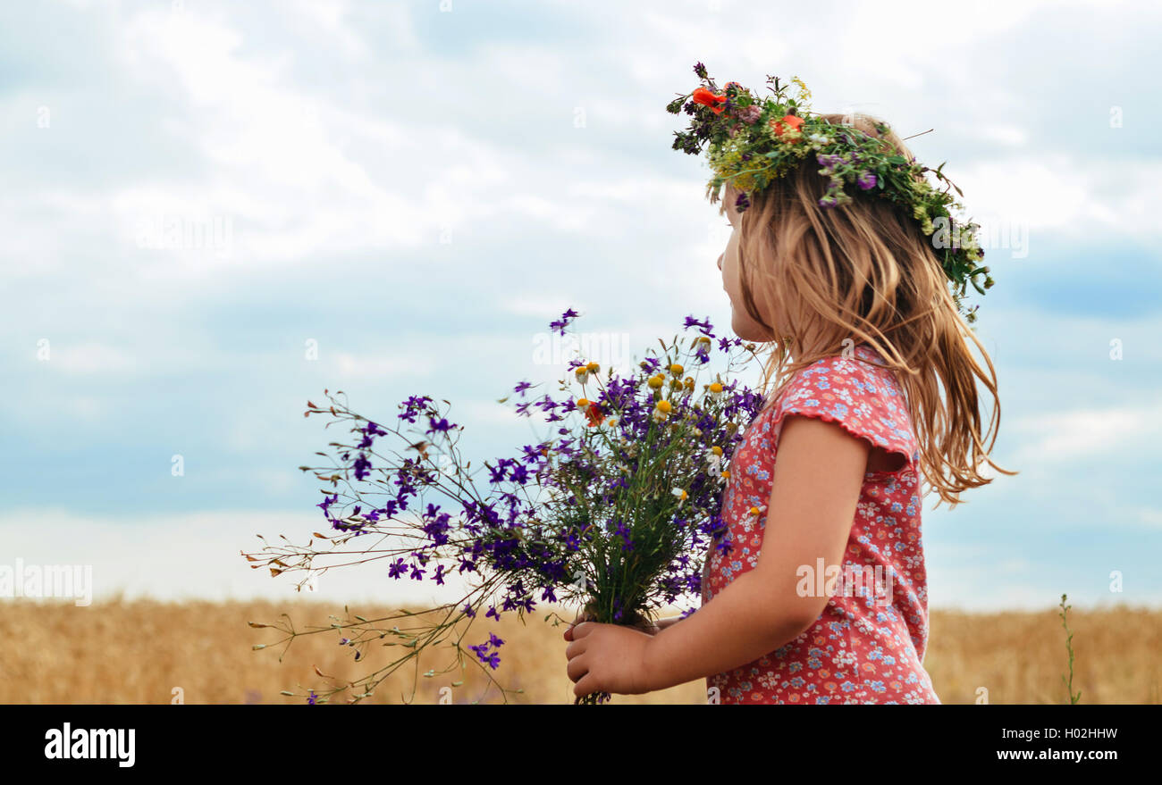 little girl with a wreath his head field of wheat Stock Photo - Alamy