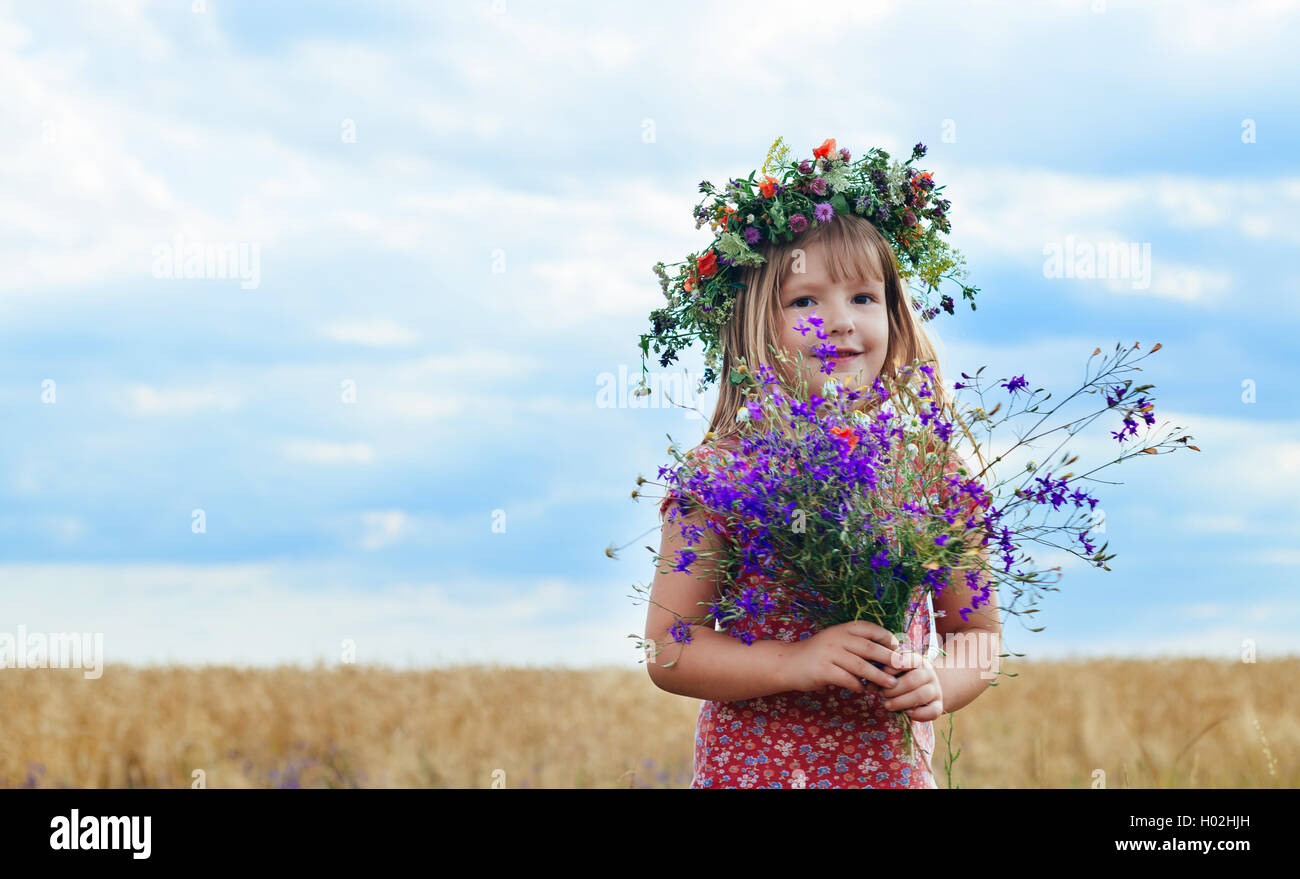 little girl with a wreath his head field of wheat Stock Photo - Alamy