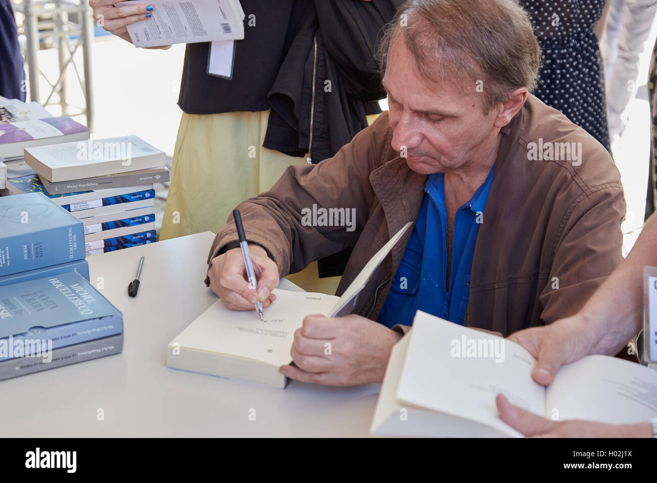 Writer Michel Houellebecq signing copies of his books during a festival Stock Photo