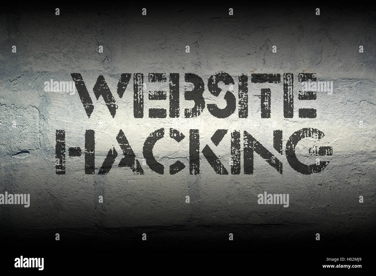 website hacking stencil print on the grunge white brick wall Stock Photo
