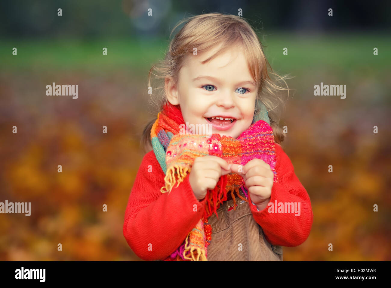 Happy little girl in the park Stock Photo - Alamy
