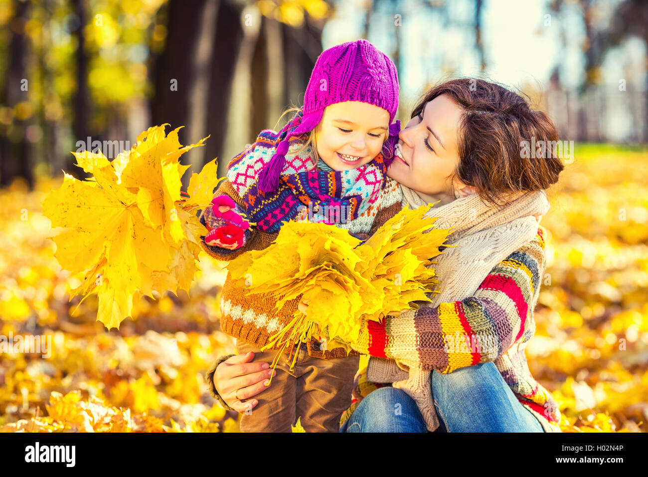 Mother and daughter playing in autumn park Stock Photo - Alamy