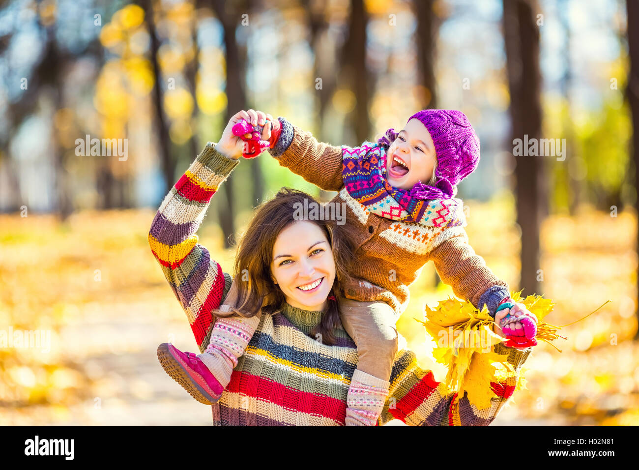 Mother and daughter playing in autumn park Stock Photo - Alamy