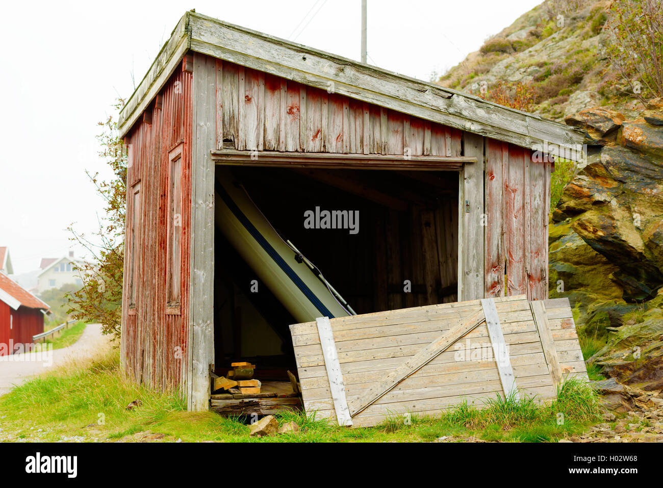Tjorn, Sweden - September 9, 2016: Environmental documentary of coastal shed with removed side door revealing an inflatable boat Stock Photo