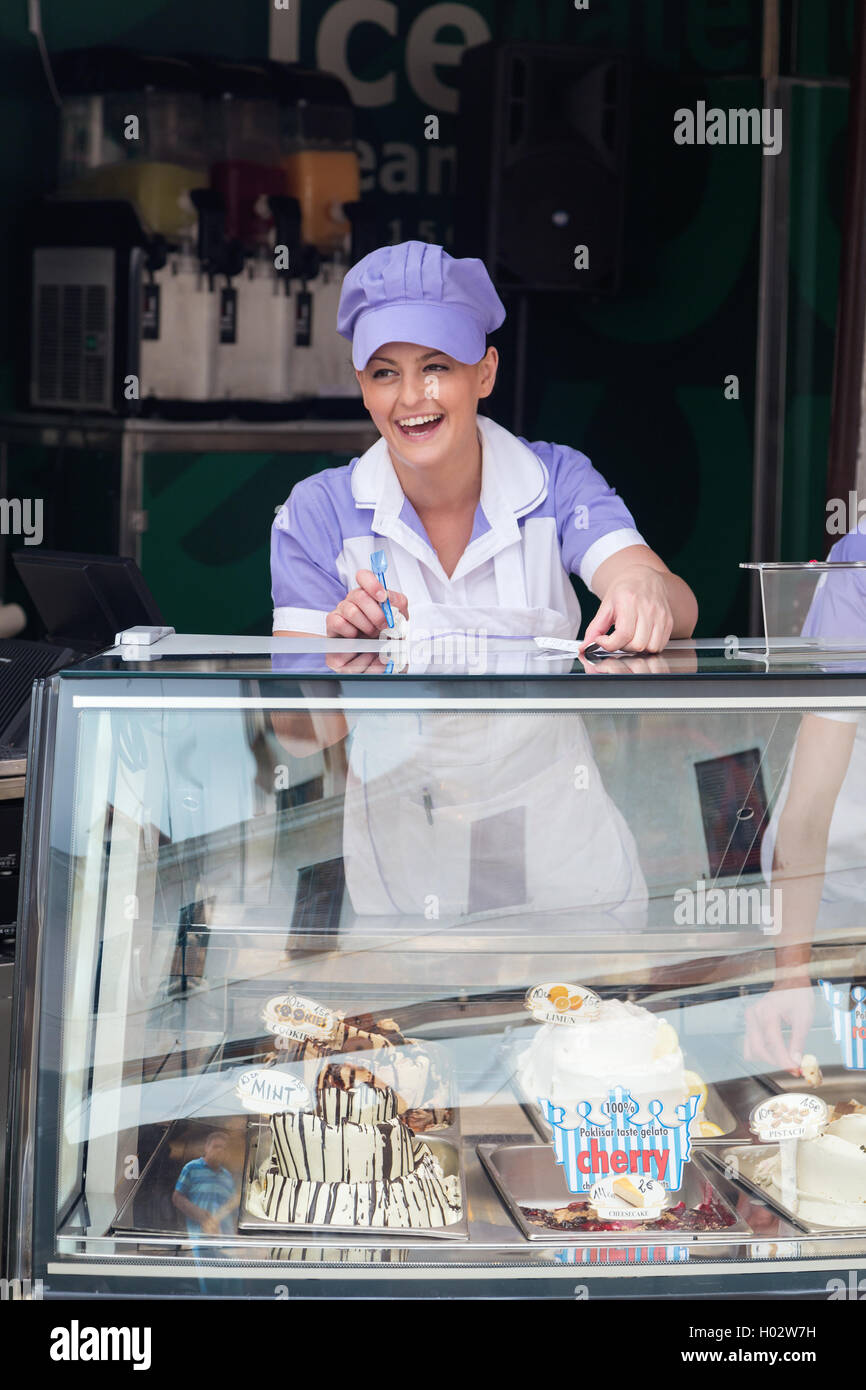 DUBROVNIK, CROATIA MAY 26, 2014 Smiling young waitress at ice cream