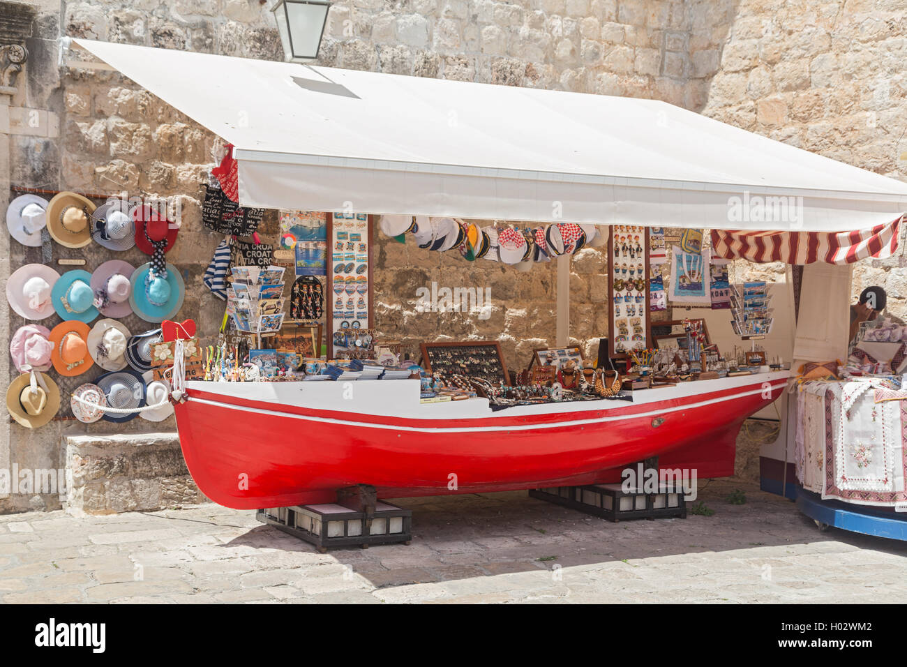 DUBROVNIK, CROATIA - MAY 27, 2014: Souvenir street stand shaped as old red boat. Stock Photo