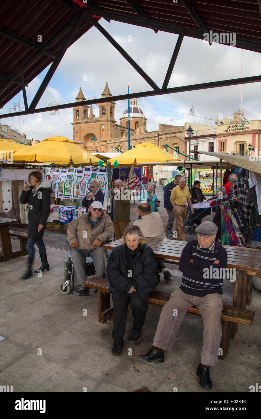 MARSAXLOKK, MALTA - JANUARY 11, 2015: People at Marsaxlokk market, one of the city's main features especially on sunday. Stock Photo