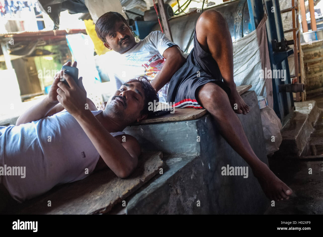 MUMBAI, INDIA - 08 JANUARY 2015: Indian workers taking a rest after an early morning shift in Dhobi ghat. Stock Photo