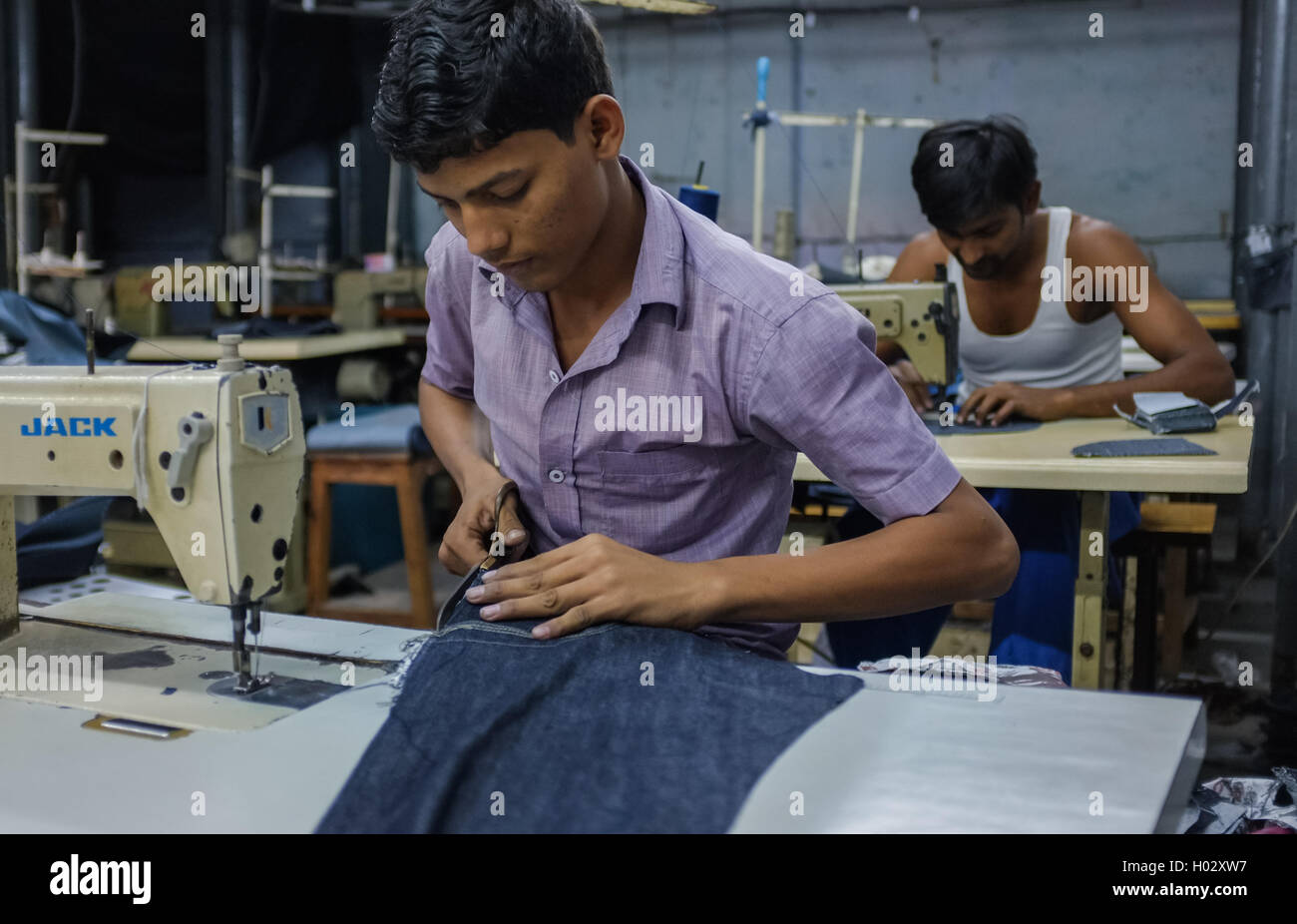 MUMBAI, INDIA 12 JANUARY 2015 Indian workers sewing in a clothing factory in Dharavi slum