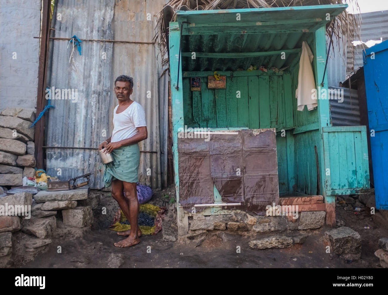 KAMALAPURAM, INDIA - 02 FEBRUARY 2015: Indian man heating coal for iron in a town close to Hampi Stock Photo