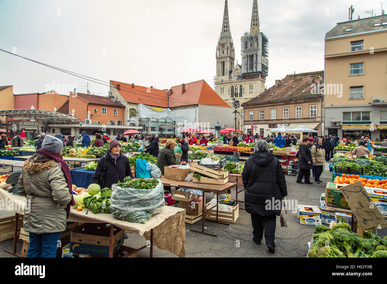ZAGREB, CROATIA - 12 MARCH 2015: Dolac market full of fruits and vegetables with a view of Zagreb Cathedral. Stock Photo