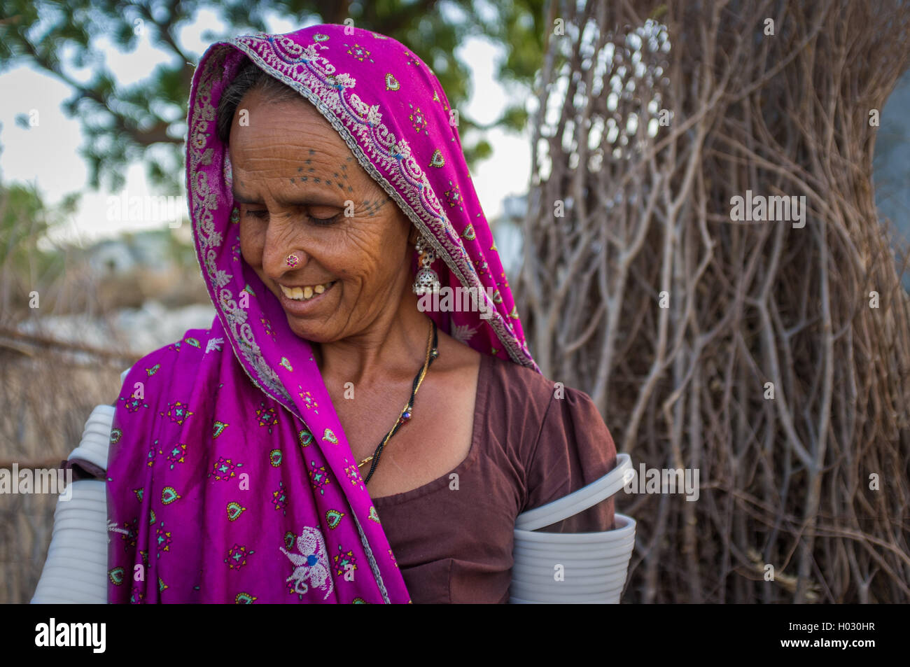 GODWAR REGION, INDIA - 12 FEBRUARY 2015: Tribeswoman decorated with traditional tattoos on face, jewelry and upper arm bracelets Stock Photo