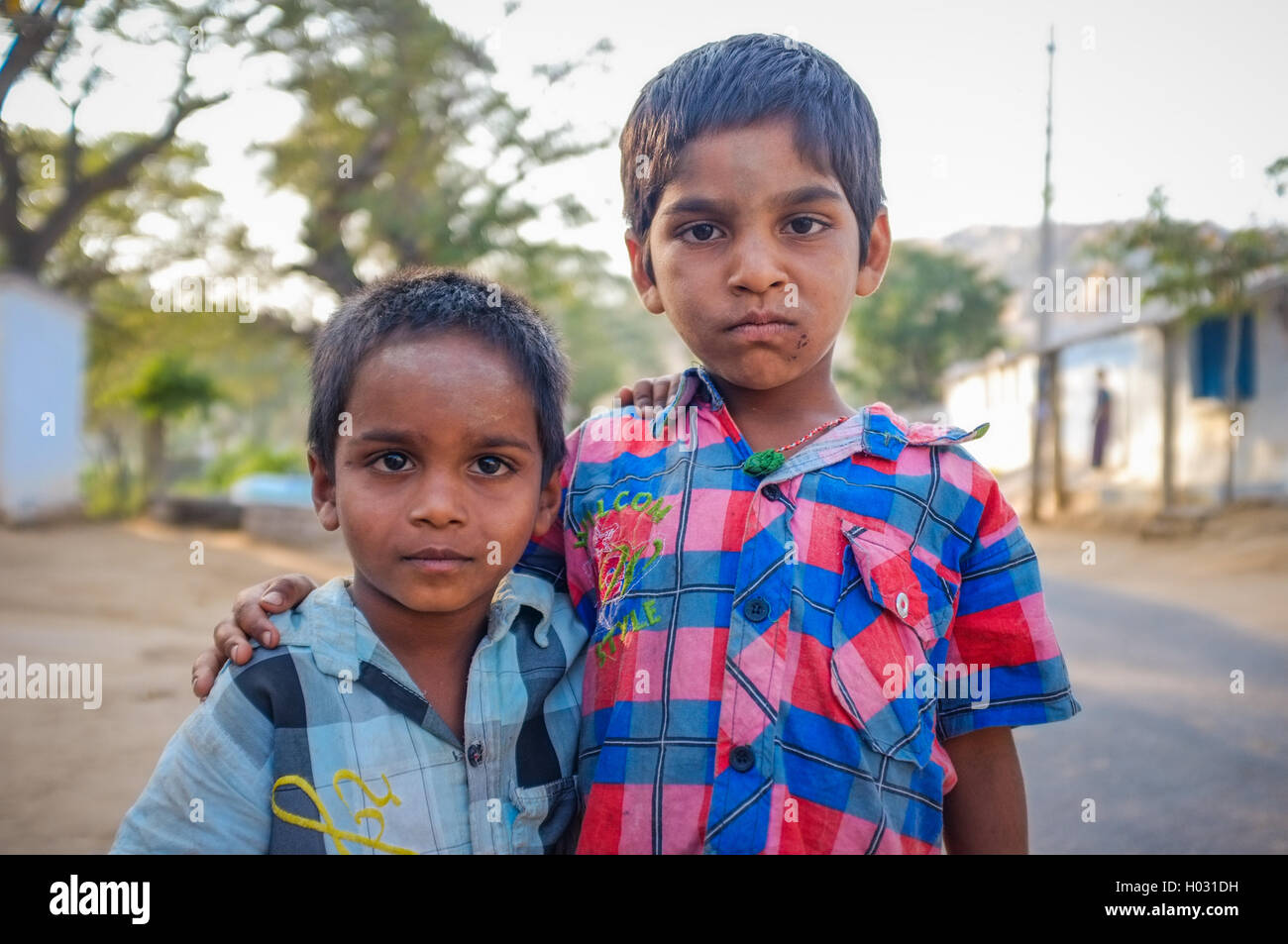 HAMPI, INDIA - 31 JANUARY 2015: Two Indian boys hugging in street Stock Photo