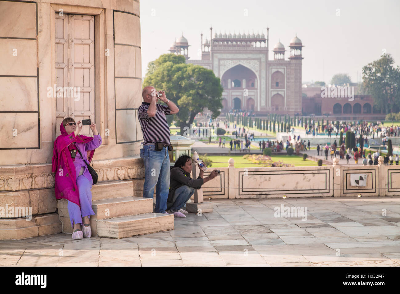 AGRA, INDIA - 28 FEBRUARY 2015: Visitors photographing Taj Mahal with Great Gate in background. Stock Photo