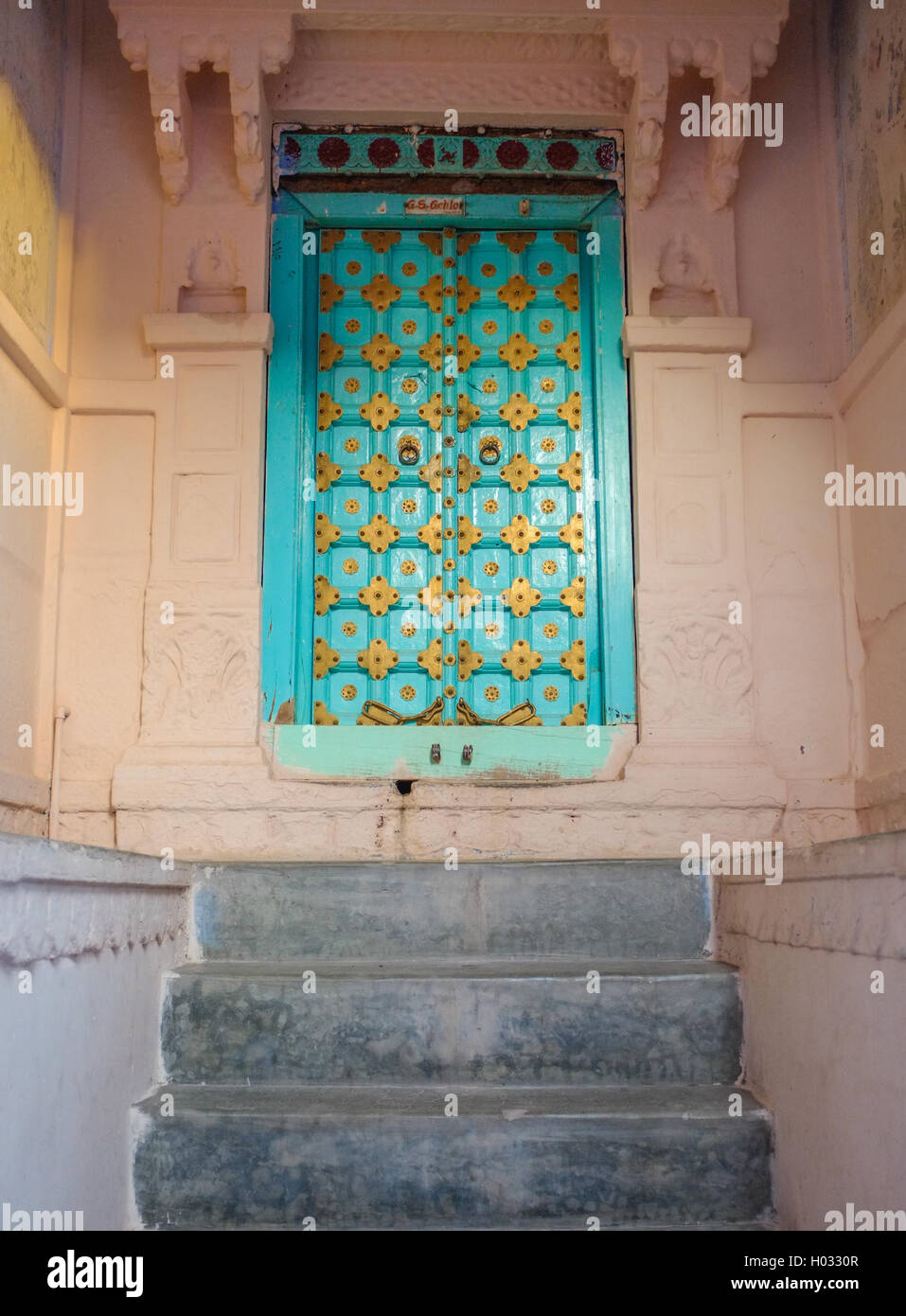 JODHPUR, INDIA - 07 FEBRUARY 2015: Entrance to home designed in typical style for Rajasthan region. Wooden door with carved deta Stock Photo